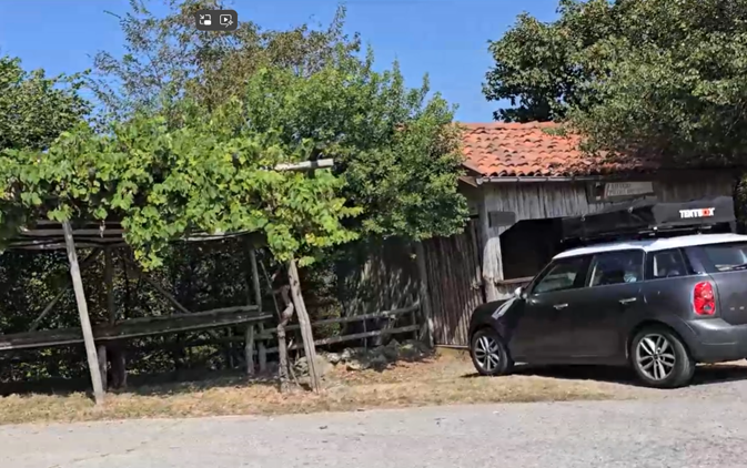 Image of a car parked at a hut